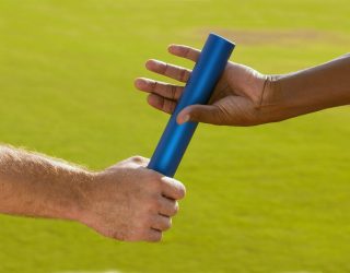 Hands Passing Baton at Sporting Event